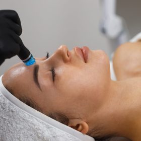 Cosmetologist making mesotherapy injection with dermapen on face for rejuvenation on the spa center.